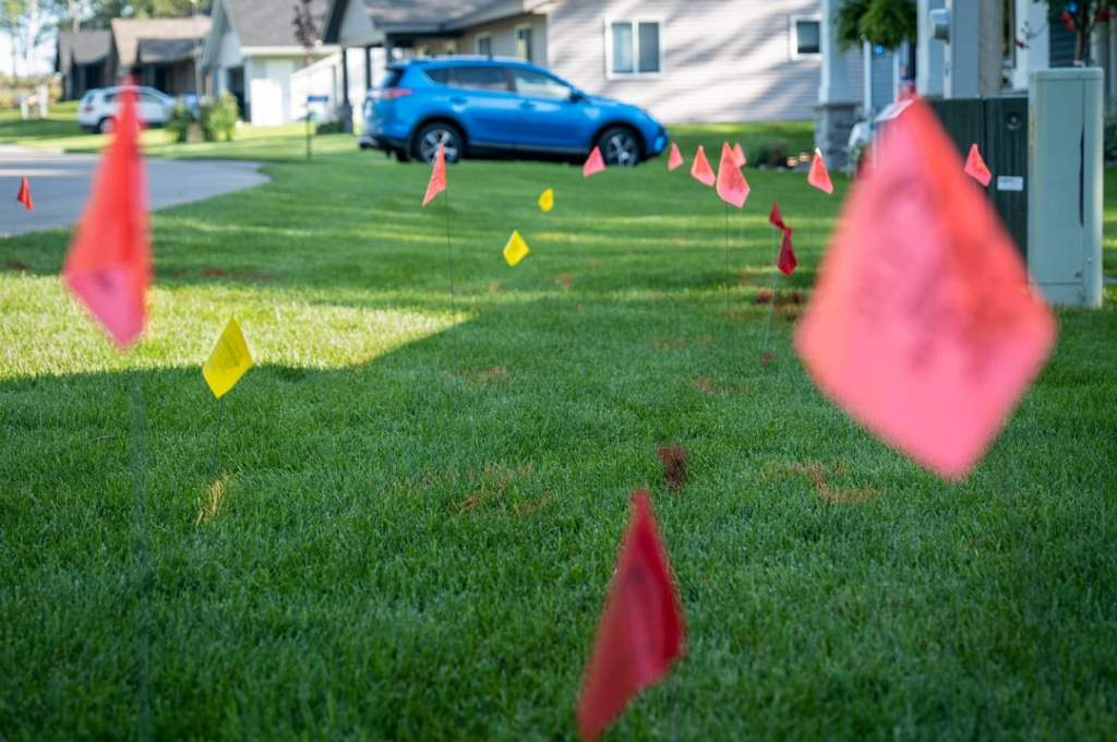 Utility Flags locating utilities in a neighborhood's yard.
