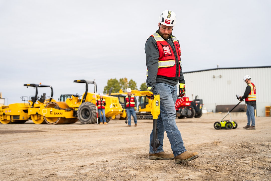 GPRS Project manager performing utility locating on a job site.