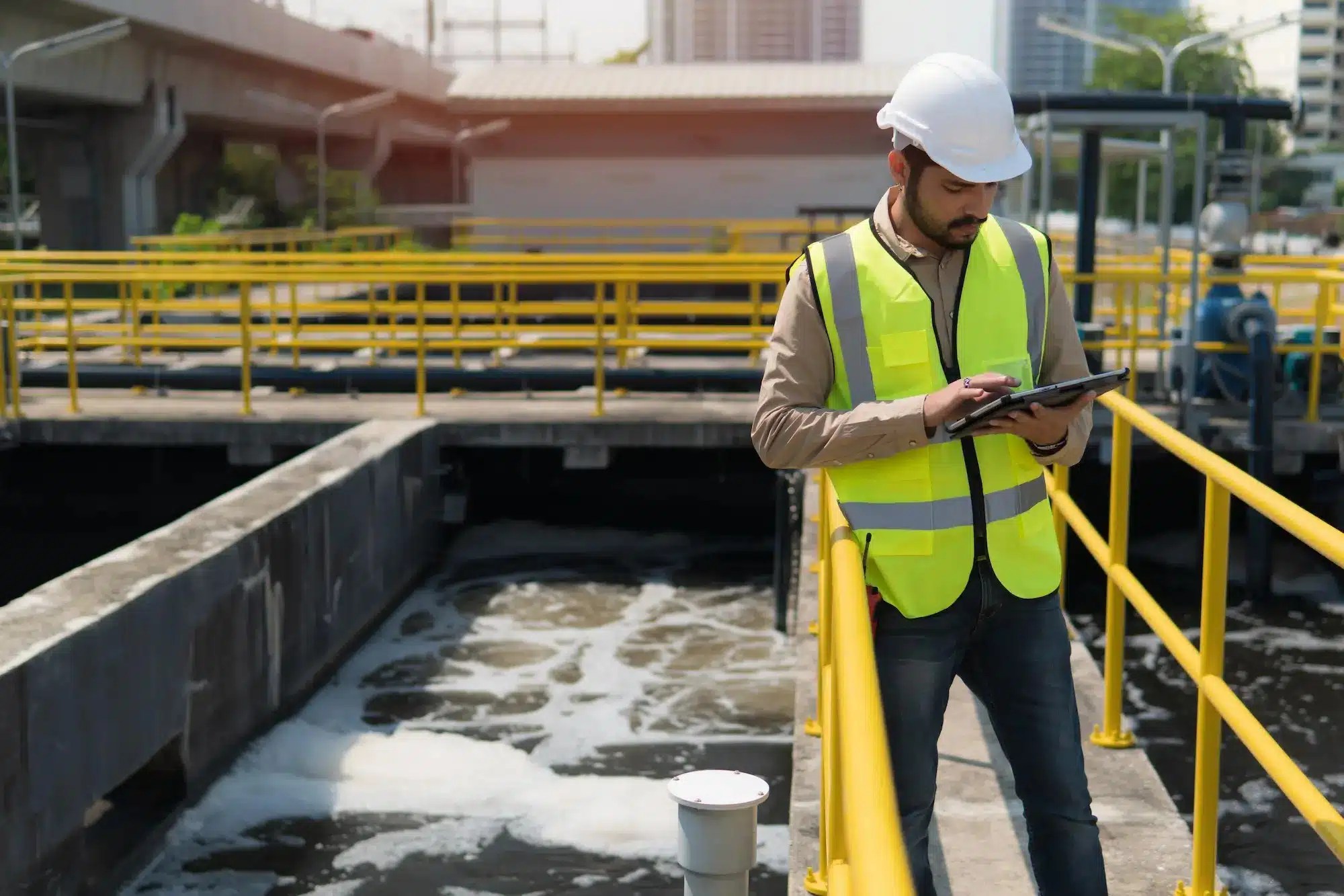 engineer checking computer at waste water facility