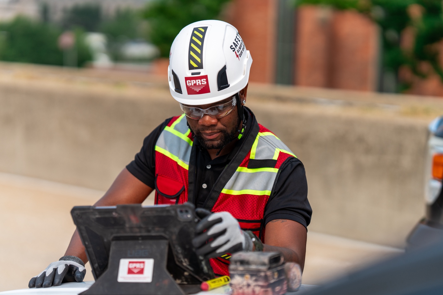 A GPRS Project Manager operating a tablet.