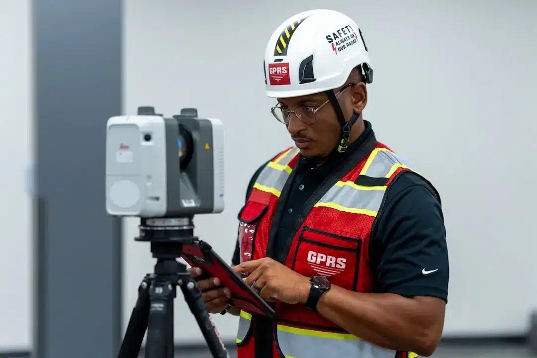 GPRS Project Manager operating a 3D laser scanner with a tablet.