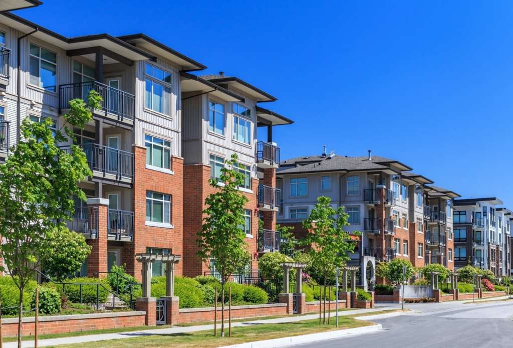 An apartment complex as viewed from the street.