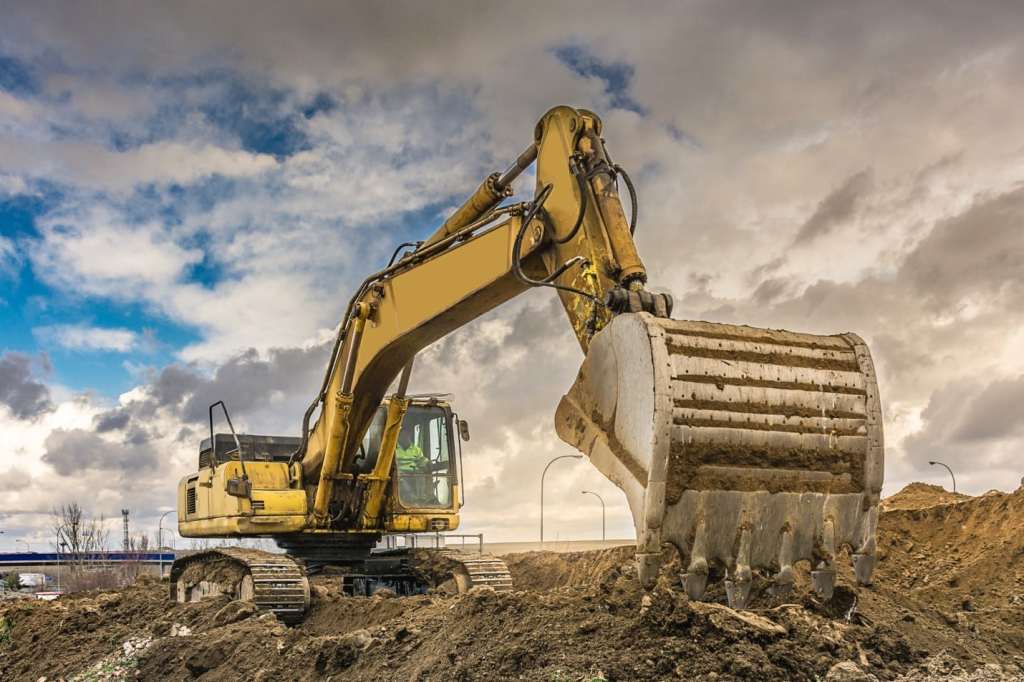 An excavator digging into the ground.