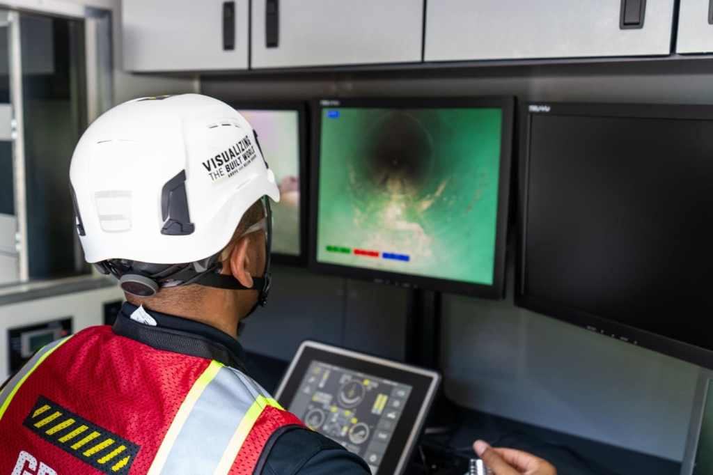 A GPRS Project Manager at the control console for a remote-controlled sewer inspection rover.